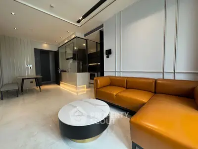 Modern living room with sleek design, featuring a luxurious leather sofa and elegant marble coffee table.