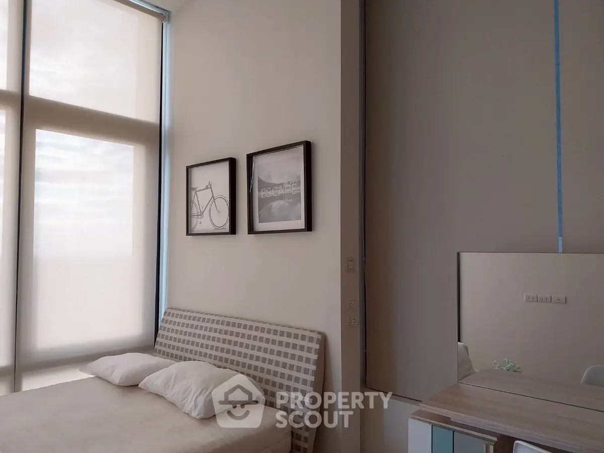 Modern bedroom with minimalist decor and large windows