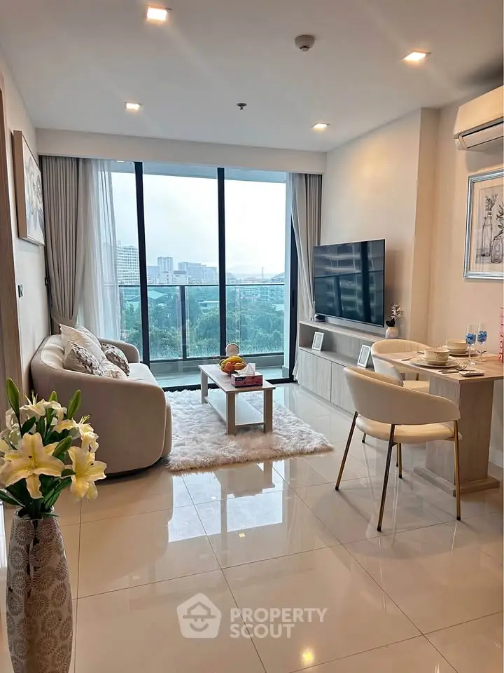 Modern living room with city view, elegant decor, and cozy seating area.