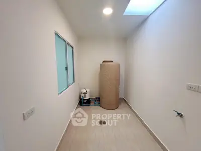 Minimalist storage room with natural light and tiled flooring