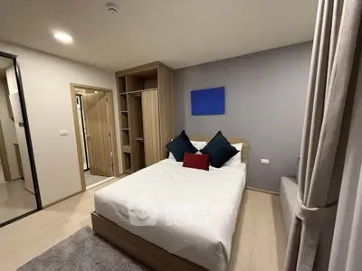 Modern bedroom with cozy bed and stylish decor in a contemporary apartment.
