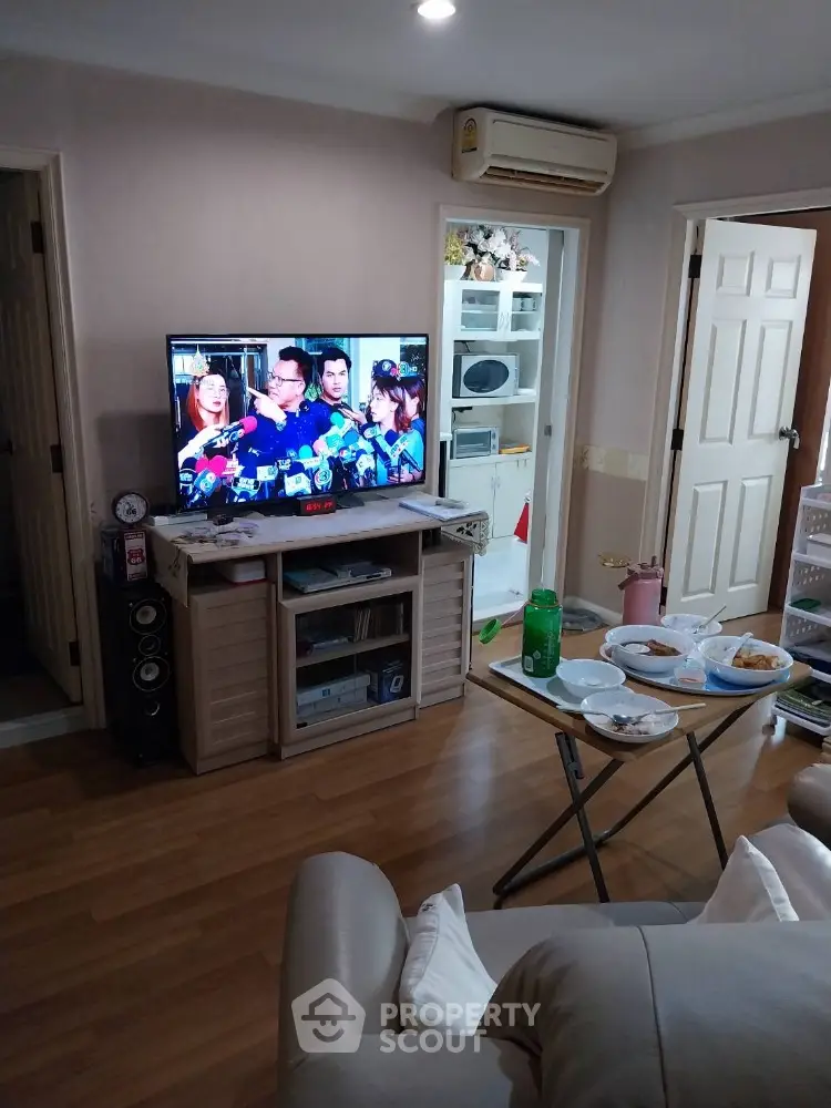 Cozy living room with wooden flooring and modern entertainment setup