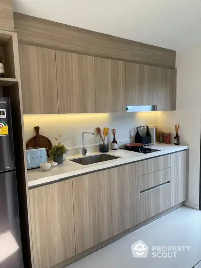 Modern kitchen with sleek wooden cabinets and integrated appliances