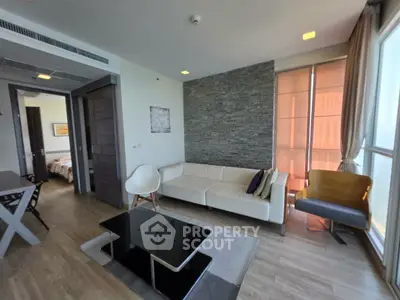 Modern living room with stylish decor and natural light in a contemporary apartment.