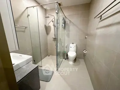 Modern bathroom with glass shower and sleek fixtures