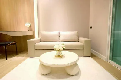 Modern living room with beige sofa, stylish coffee table, and elegant decor in a cozy apartment.