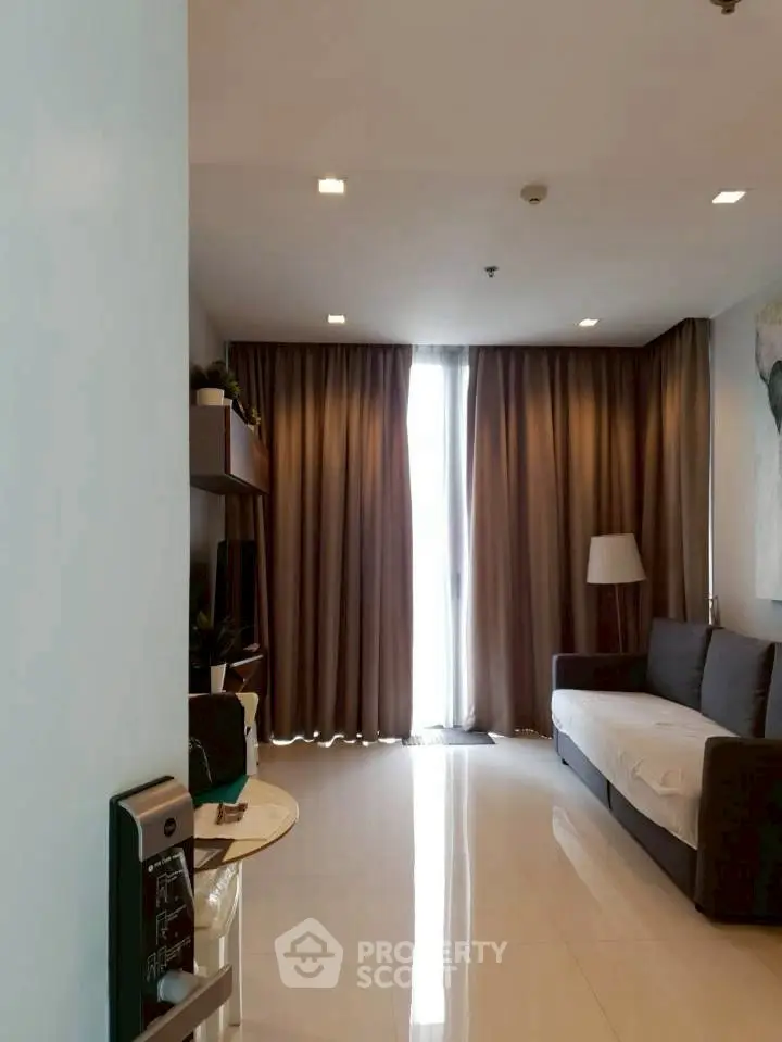 Modern living room with sleek sofa and floor-to-ceiling curtains