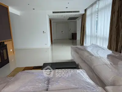 Spacious living room with modern furniture and large windows for natural light