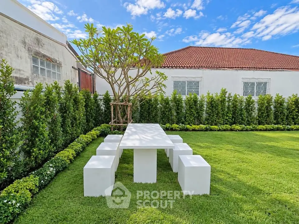Charming garden with modern outdoor dining set and lush greenery