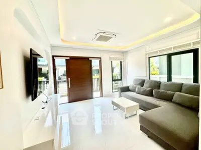 Spacious modern living room with large windows and sleek furniture