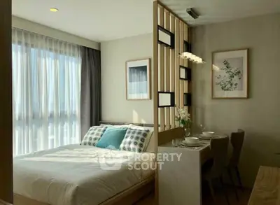 Modern bedroom with dining area, natural light, and stylish decor in a cozy apartment.