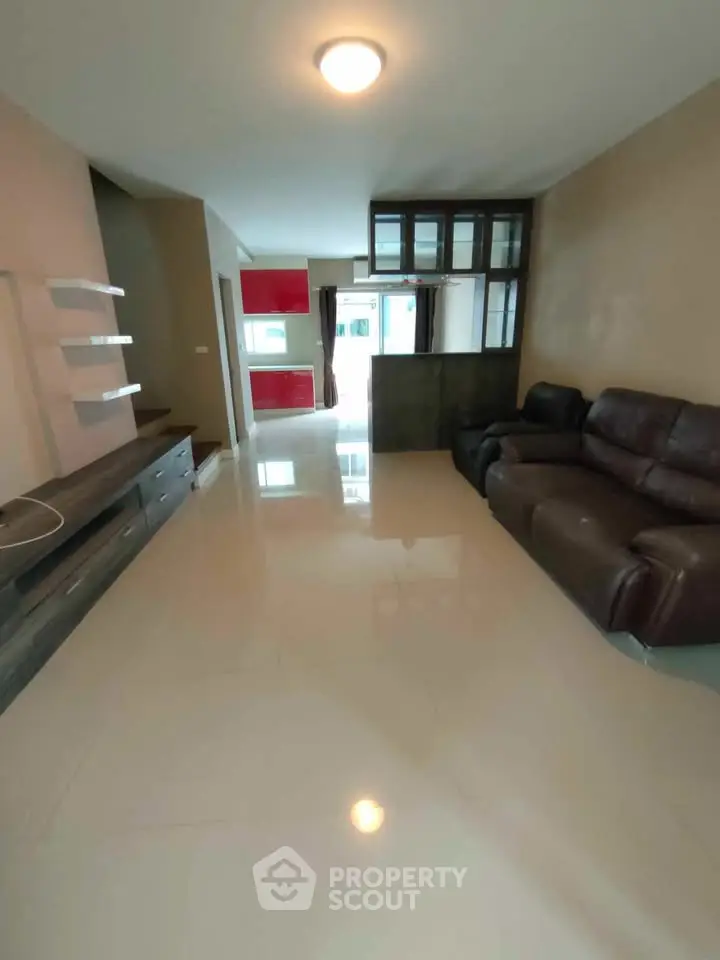 Spacious modern living room with sleek furniture and open layout, perfect for contemporary living.