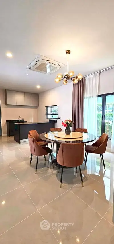 Modern dining area with elegant lighting and open kitchen layout