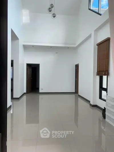 Spacious modern living room with high ceilings and large windows