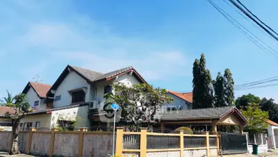 Charming suburban house with tiled roof and lush garden, perfect for family living.