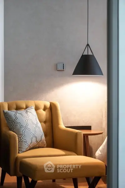 Stylish modern living room corner with mustard armchair and pendant light
