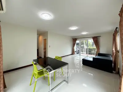 Spacious modern living room with sleek furniture and large windows for natural light.