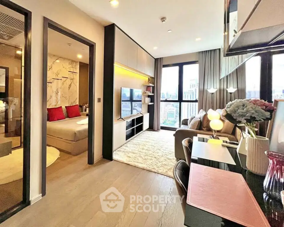 Modern living room with city view, stylish decor, and cozy ambiance in a high-rise apartment.