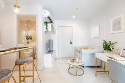 Modern living room with elegant decor and open layout, featuring cozy seating and stylish accents.