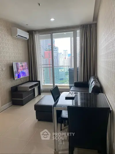 Modern living room with city view, sleek furniture, and natural light in a high-rise apartment.