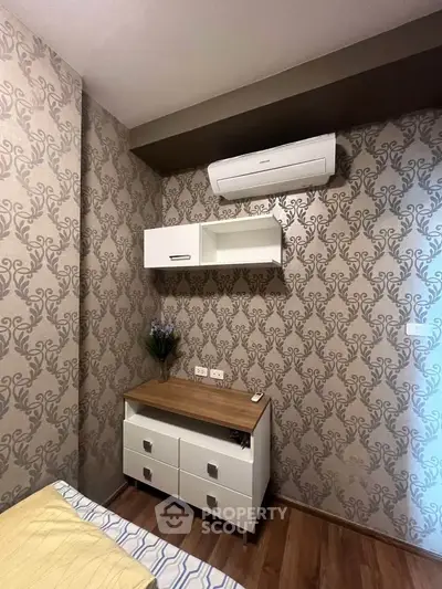 Cozy bedroom with elegant wallpaper and modern air conditioning unit