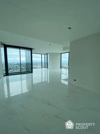 Spacious modern living room with panoramic city views and large windows.