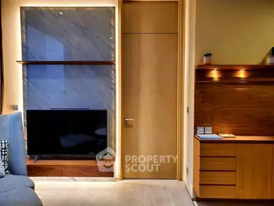 Modern living room with sleek wooden cabinetry and mounted TV