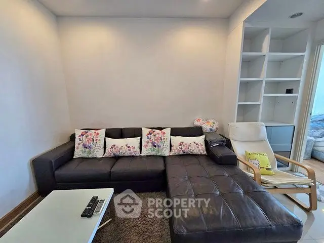 Modern living room with stylish black leather sectional sofa and cozy decor