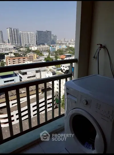 High-rise balcony with washing machine and stunning cityscape view