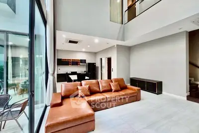 Spacious modern living room with high ceilings and open kitchen layout