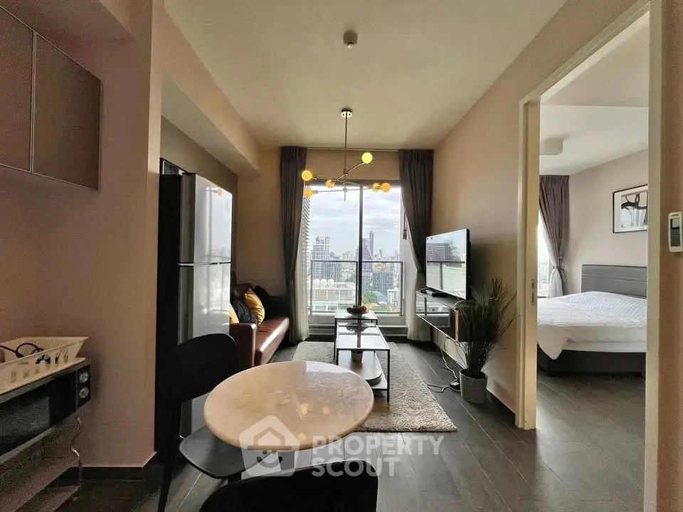 Modern apartment with open living room and city view, featuring sleek furniture and contemporary lighting.