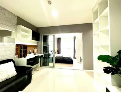 Modern living room with sleek design and open view to bedroom