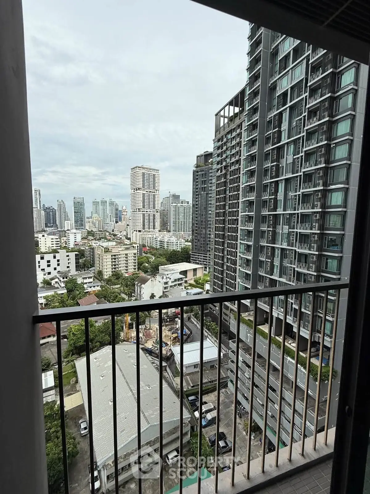 Stunning cityscape view from a high-rise balcony in a modern urban setting.