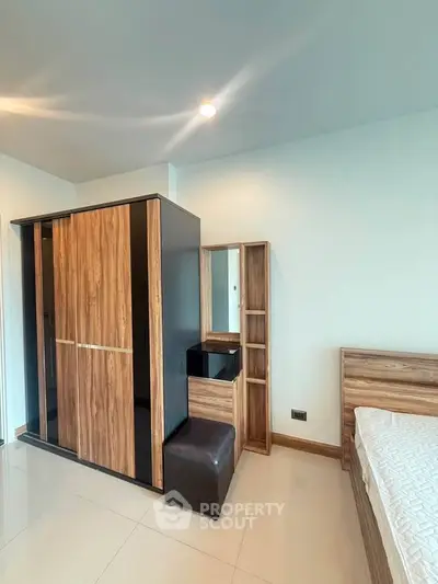 Modern bedroom with sleek wooden furniture and ample storage space