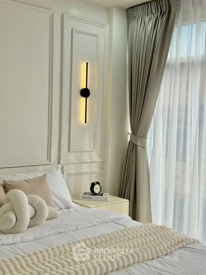 Elegant bedroom with modern decor and natural light