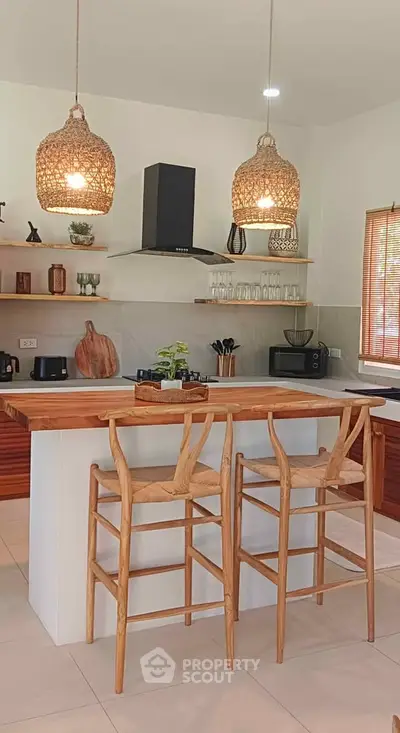 Charming kitchen with wooden accents, island seating, and modern appliances, perfect for culinary enthusiasts.