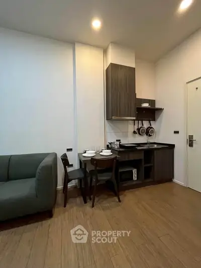Modern compact kitchen with dining area in cozy apartment