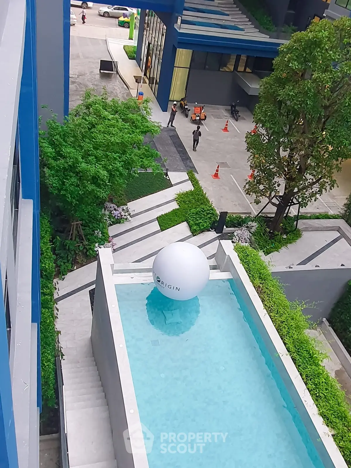 Modern apartment complex with stylish pool and lush greenery, offering a luxurious urban lifestyle.
