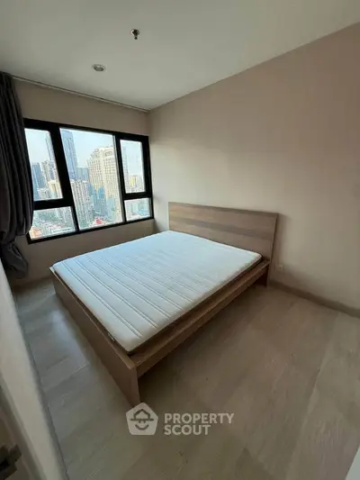 Spacious bedroom with city view and natural light in modern apartment