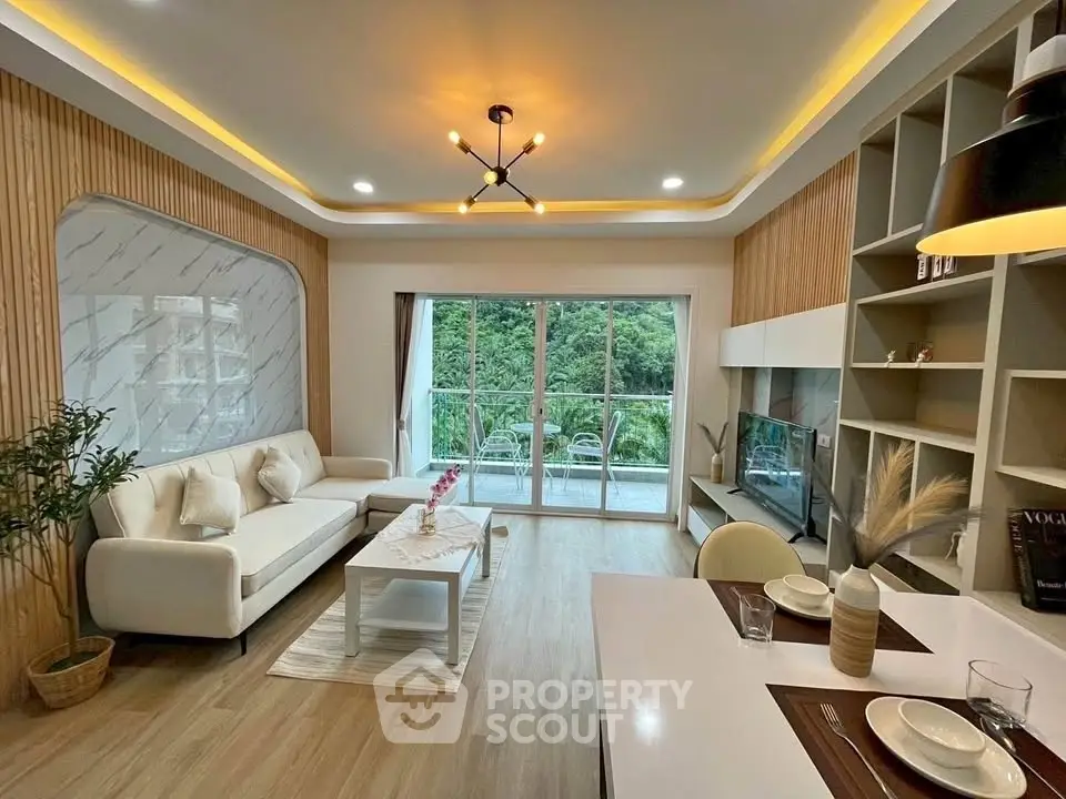 Modern living room with elegant decor and large windows offering scenic views.