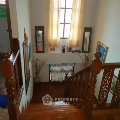 Charming wooden staircase with elegant decor and natural light