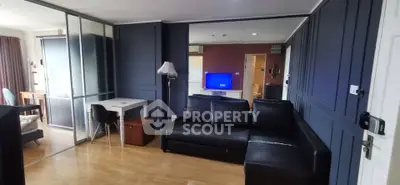 Modern living room with sleek black sofa and stylish decor