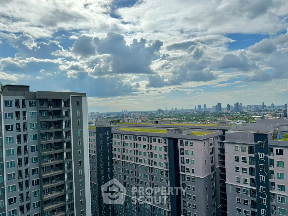 Stunning cityscape view from high-rise apartment with expansive skyline and modern architecture.