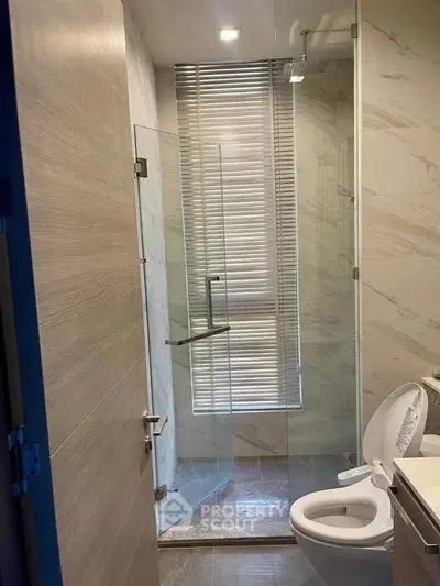 Modern bathroom with glass shower and sleek fixtures