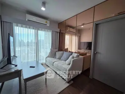 Modern living room with large windows and cozy sofa in a stylish apartment.