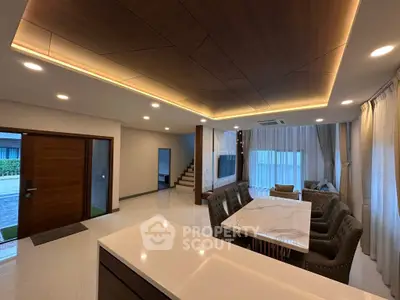 Luxurious open-plan living room with elegant dining area and modern lighting