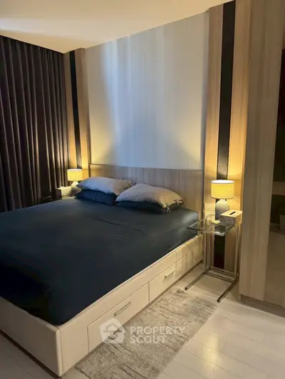 Modern bedroom with stylish decor and cozy lighting, featuring a comfortable bed and elegant side tables.