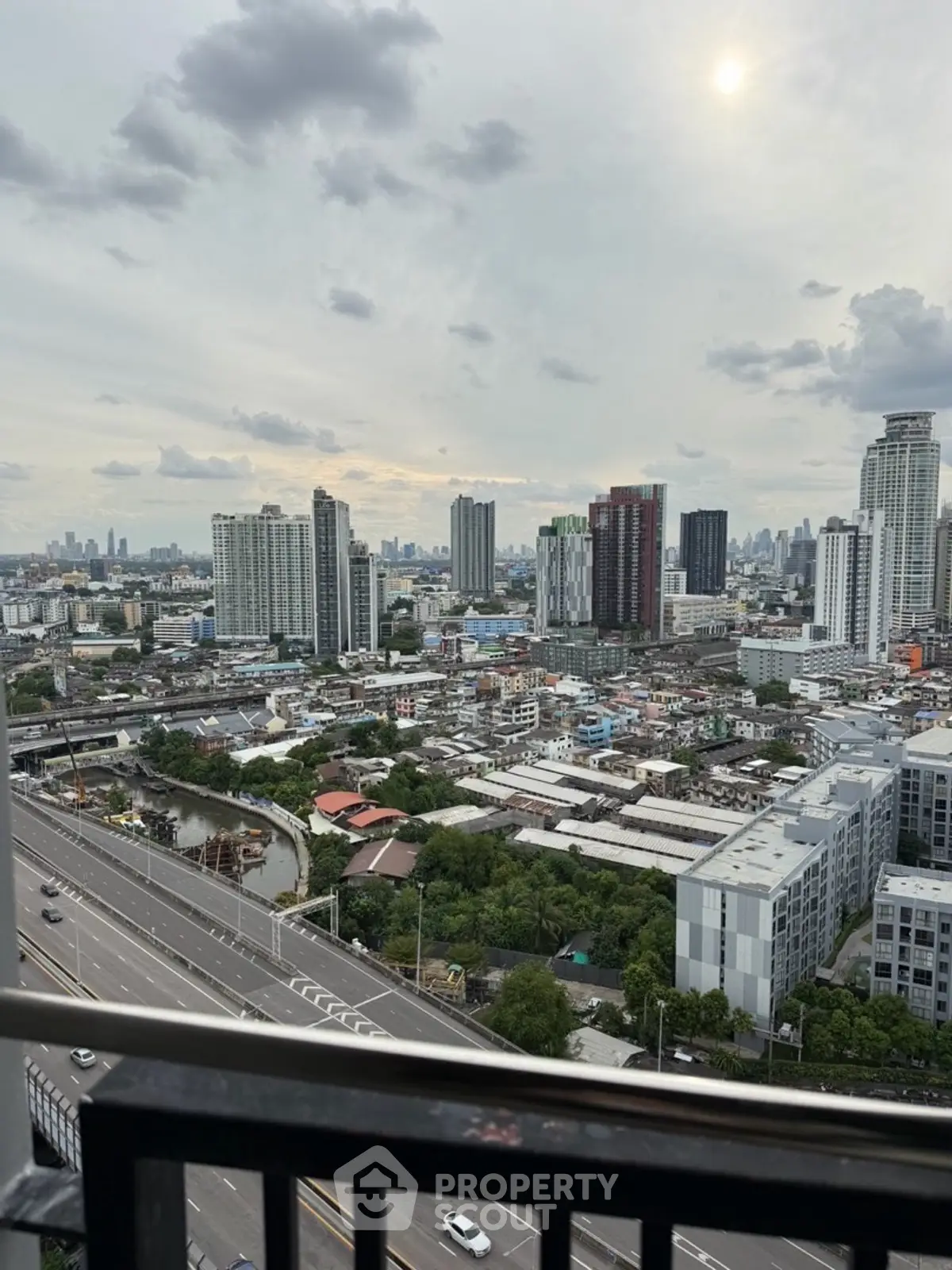 Stunning cityscape view from high-rise balcony overlooking urban skyline.