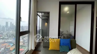 Modern living room with city view and cozy balcony access