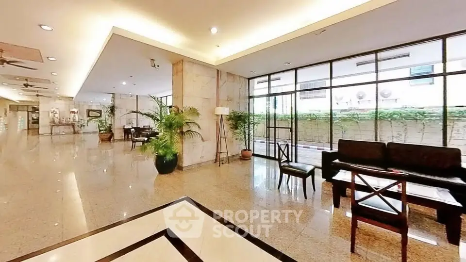 Spacious and elegant lobby with modern decor and ample natural light.